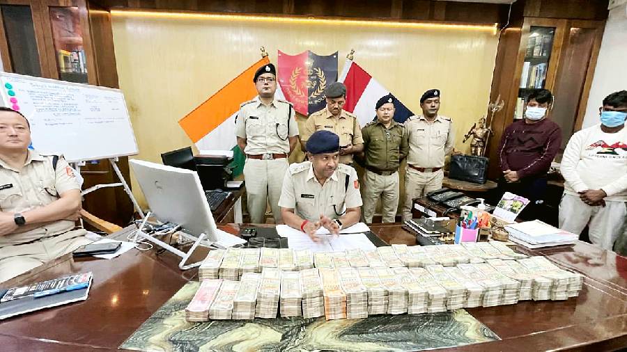 Jalpaiguri district police chief Biswajit Mahato with the seized cash in his office on Monday