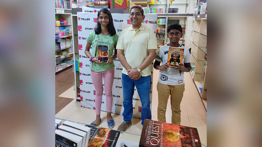 The author poses with young readers at The Storyteller Bookstore