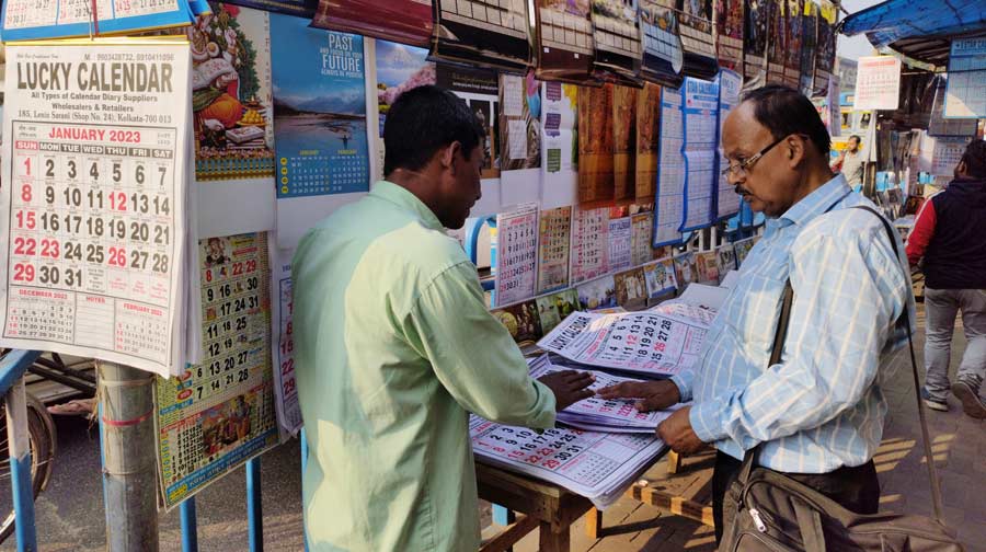 With 2023 approaching, a man at Dharmatala checks out on calendars for the new year