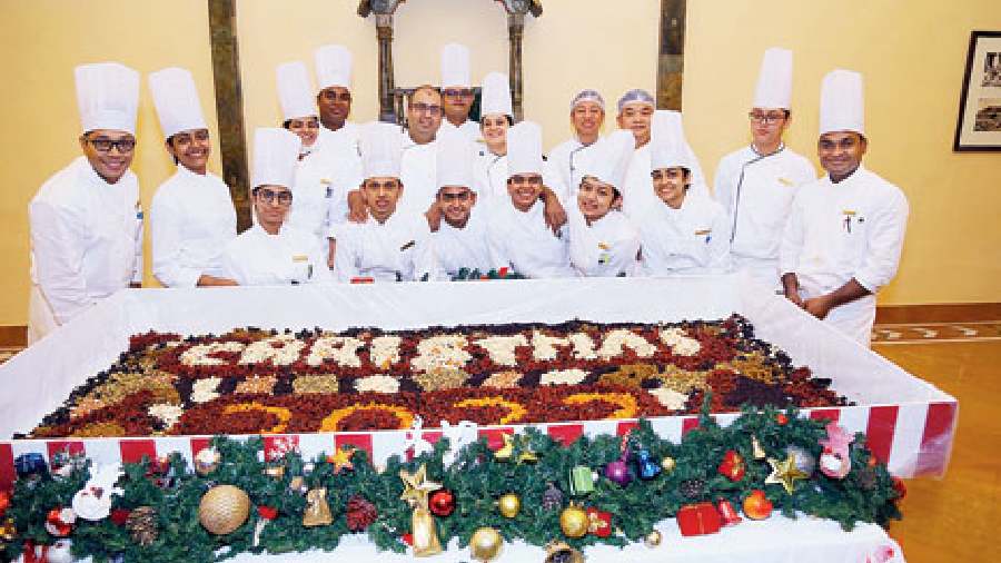 Prafull Aina, executive chef, The Oberoi Grand, with his team at the cake-mixing ceremony