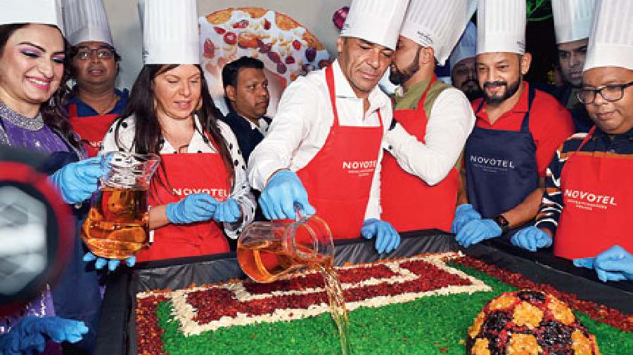 Guests take part in the cakemixing ceremony with an assortment of dry fruits and rum