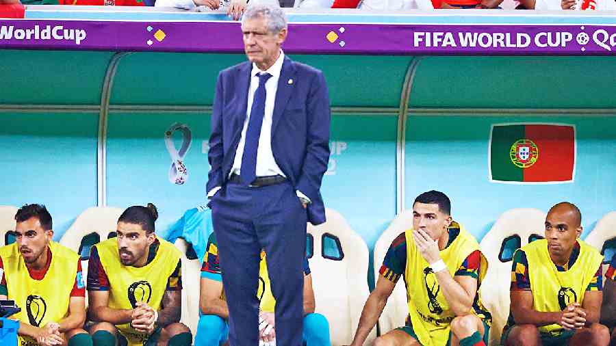 Portugal coach Fernando Santos (standing) had benched captain Cristiano Ronaldo (sitting) who watches the match from the subs’ corner. Ronaldo came on in the 74th minute by which the time the match was done and dusted.