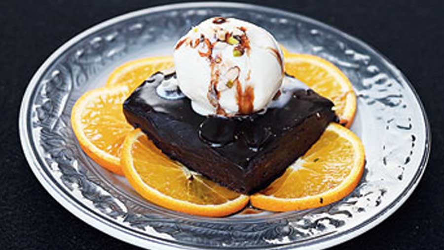 Brownie with ice cream: This gooey chocolatey brownie has the right amount of fudginess and is served on a bed of oranges.