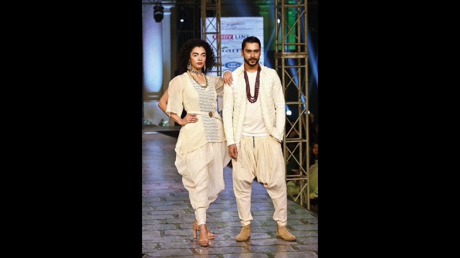 Shubhamita Banerjee was in a Chanderi textured kurta paired with dhoti pants and custom leather belt. Kutubuddin Sheikh complemented the look in a panelled and woven cotton lapel jacket with low-crotch dhoti pants.