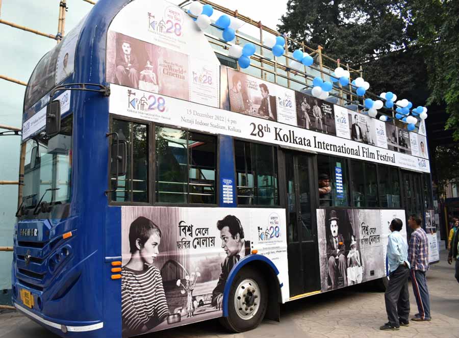 A double-decker bus near Nandan decorated with posters of iconic actors and characters from the world of cinema for the upcoming 28th Kolkata International Film Festival on Saturday
