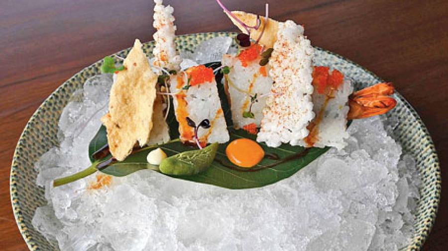 Roots Pyramid: Made with prawn tempura, this sushi pyramid comes on a bed of crushed ice and is served with an array of Indian papads