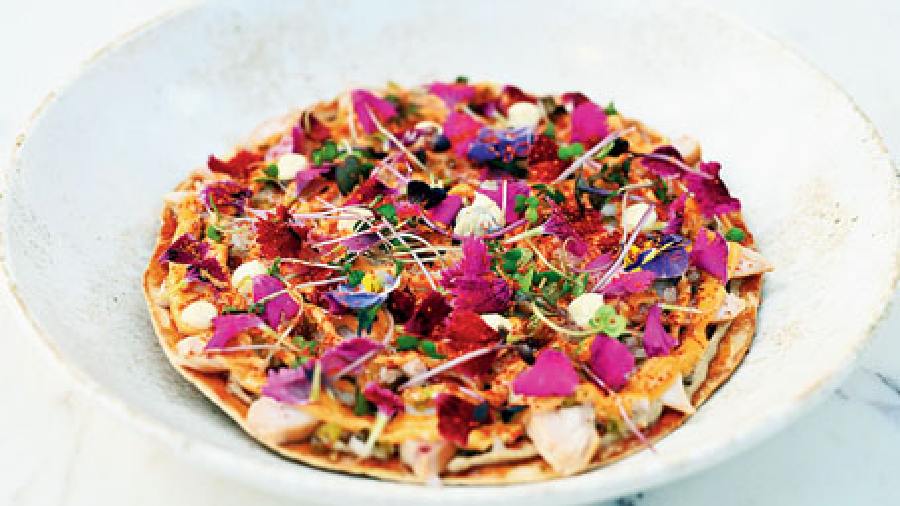 Togarashi Smoked Chicken: An interesting one on the menu, this cold pizza is too pretty to bite into. Garnished with edible flowers and chunks of delicious smoked chicken and a crispy base, this is a must-try