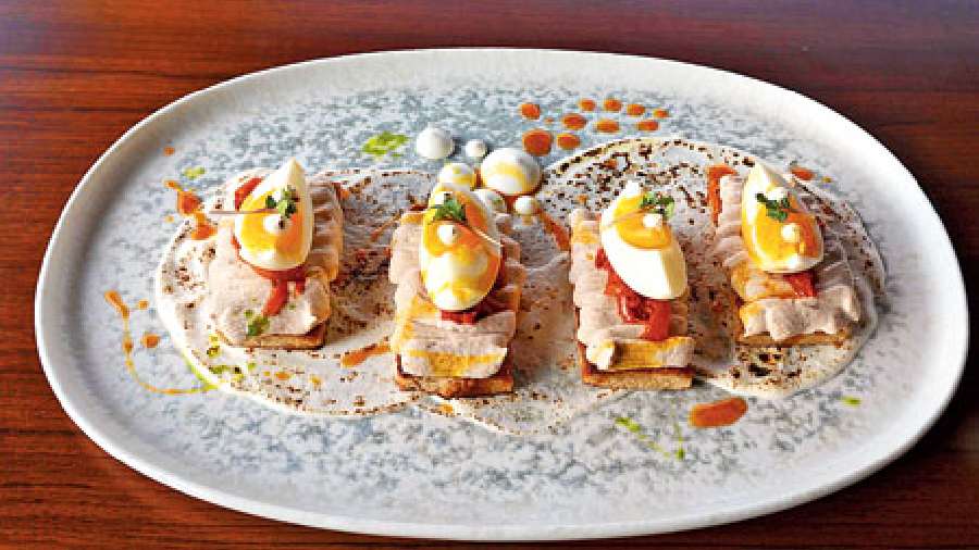 Chicken Egg Toast: A bite-sized starter made with in-house whole wheat bread that comes with malai chicken tikka mousse and is topped with organic ghee roast egg. Relish this with drops of orange marmalade that lend a bitter-sweet taste