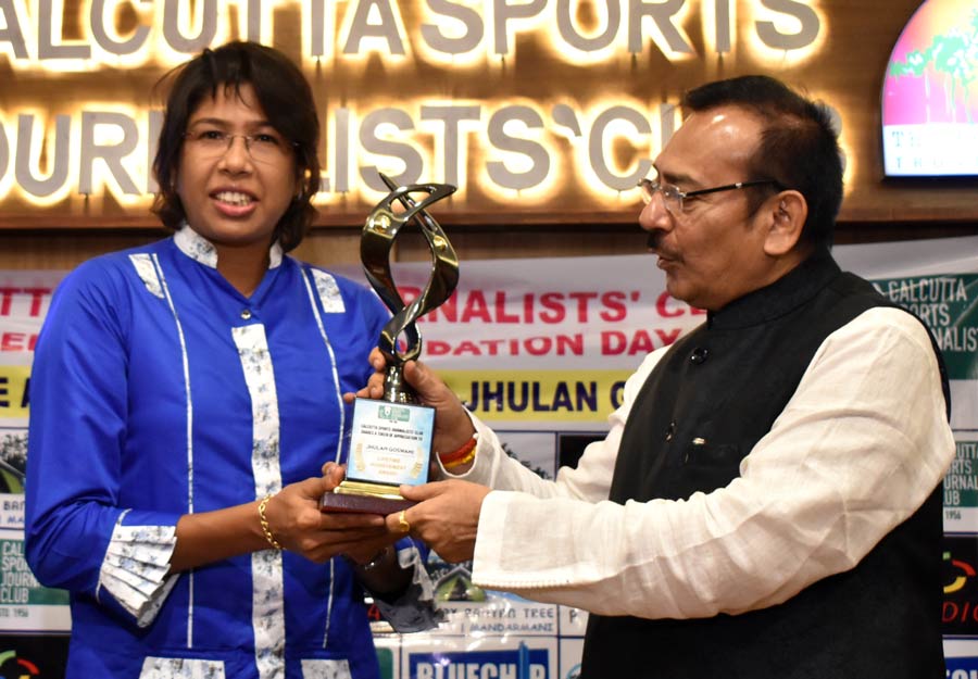 Aroop Biswas, minister-in-charge, Department of Power, Government of West Bengal hands over the Lifetime Achievement Award to cricketer Jhulan Goswami at the 67th foundation day celebrations of Calcutta Sports Journalist Club on Monday
