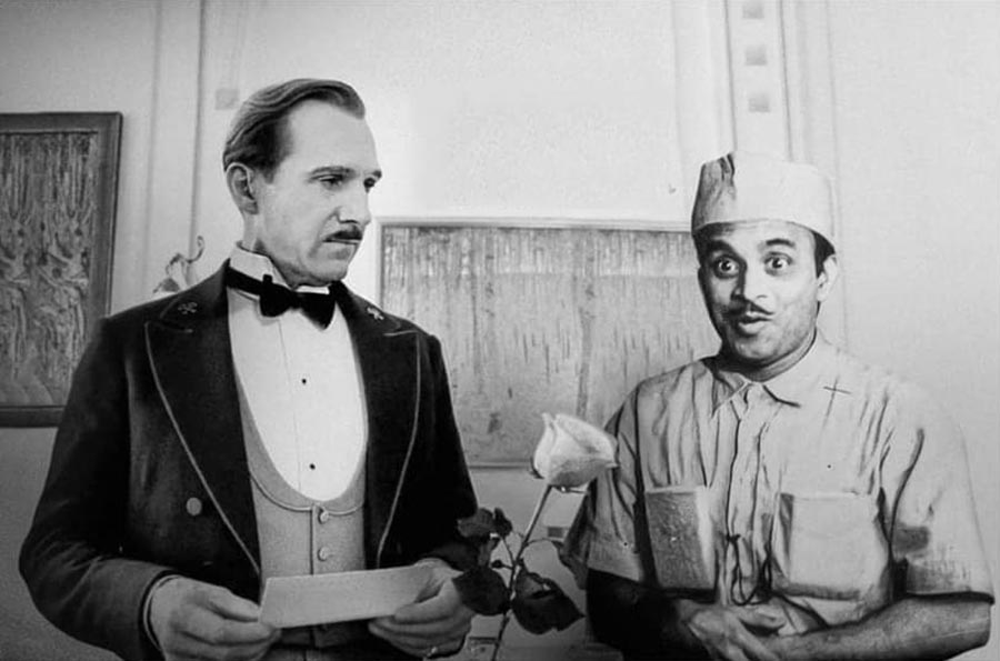 Ralph Fiennes from The Grand Budapest Hotel (2014) is seen in another poster with  Rabi Ghosh from Galpa Holeo Satyi (1966). 