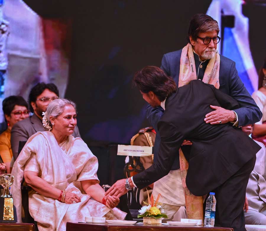 Shah Rukh Khan greets the Bachchan couple at the event. Capture-worthy star interactions marked the inauguration
