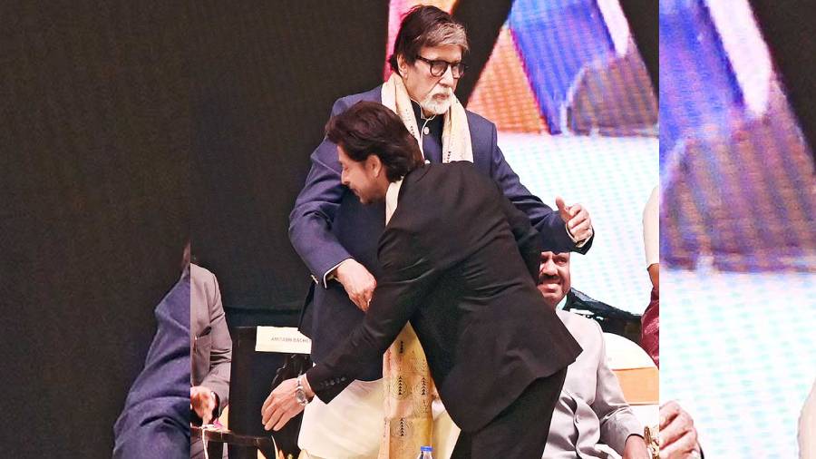 Shah Rukh Khan greets Amitabh Bachchan at the 28th Kolkata International Film Festival on Thursday. 