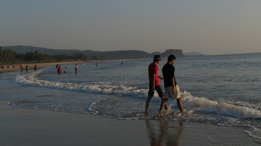 Tourists wading in the sea at Kashid beach
