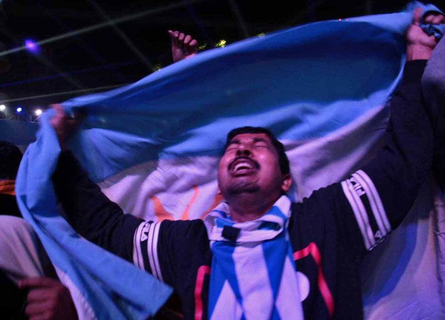 A fan reacts as Argentina lifts the coveted trophy. Several areas of Kolkata and other parts of Bengal were awash in blue and white flags as the South American nation won the cliffhanger in a tie-breaker