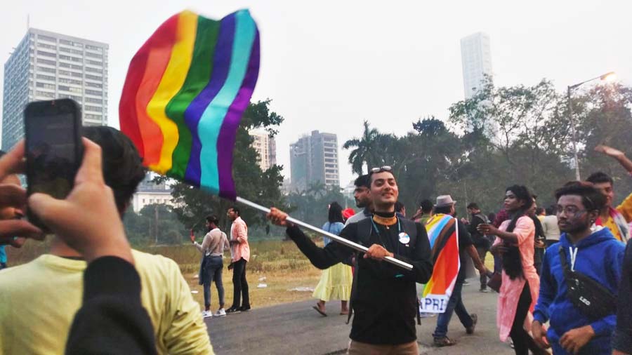 Participant waving the Pride flag at Maidan