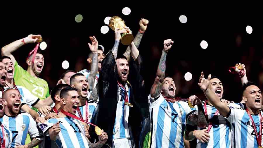 A jubilant Team Argentina, led by Lionel Messi, with World Cup 2022 at Lusail Stadium, Doha, on Sunday. 