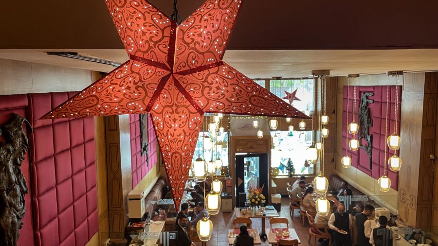 People dine at a restaurant decorated in the theme of Christmas and New Year in Connaught Place in New Delhi. 