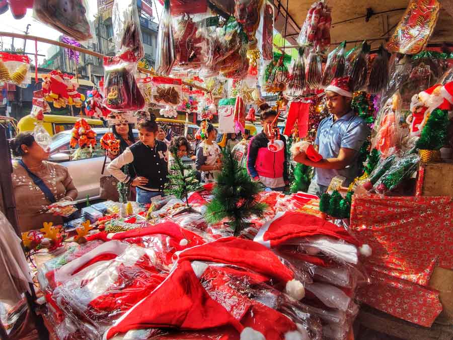 People finish their last-minute Christmas shopping at a stall in north Kolkata