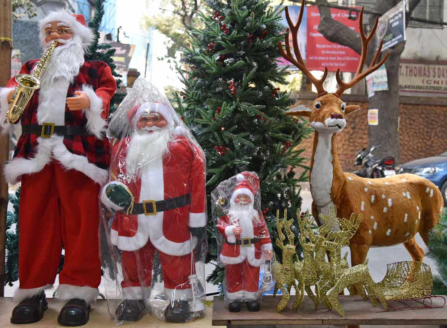Santa Claus dolls and other Christmas decorations on sale at New Market on Friday