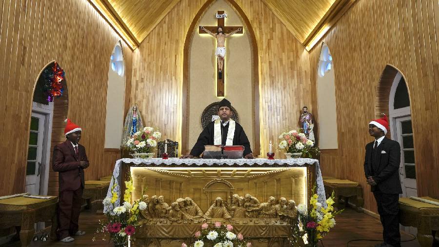 Father of Holy Family Catholic Church leads a special prayer during Christmas celebrations, in Srinagar.