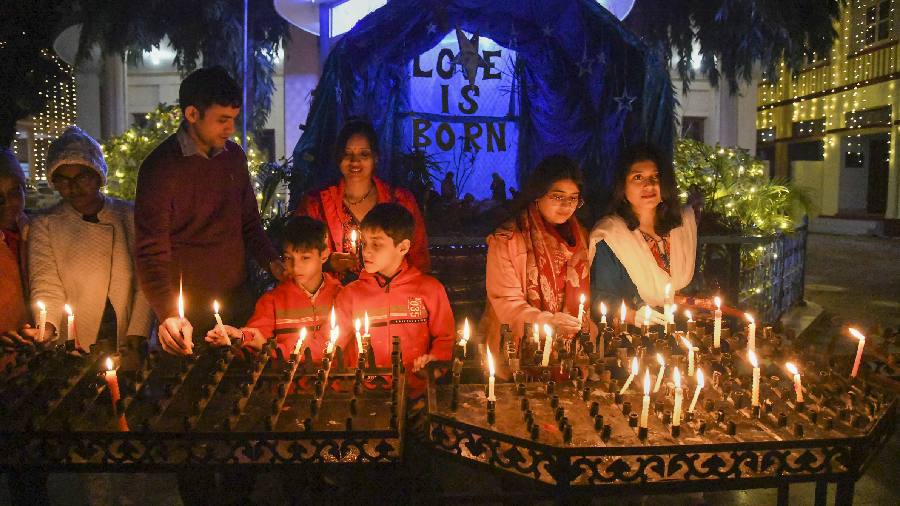 People light candles on the eve of Christmas at Catholic Church, in Patna. 