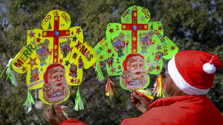 Kite maker Jagmohan Kanojia wearing Santa Claus cap displays kites in Amritsar. 