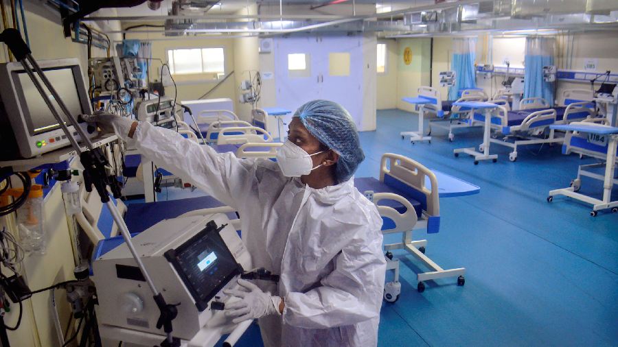 A medic at Thane Municipal Corporation's Covid Center checks equippment as part of preparedness in the wake of surge in cases in some countriues, in Thane. 