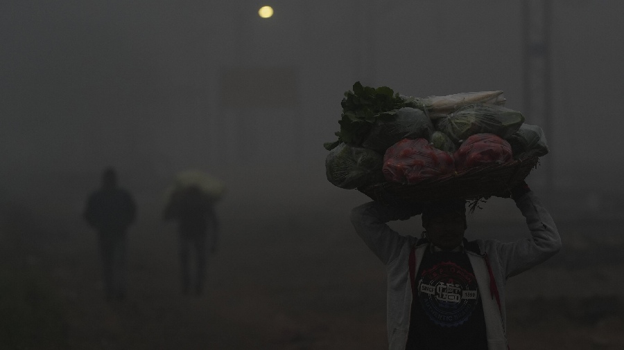 The agency’s evening forecast on Monday also predicted dense to very dense fog over parts of Punjab, Haryana, Delhi, Uttarakhand and western Rajasthan over the next two days. A vegetable vendor walks during a cold and foggy morning, in New Delhi. 