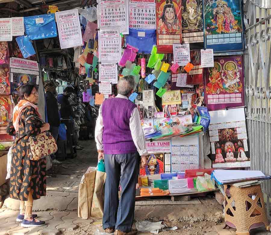As we bid adieu to 2022, people take a look at 2023 calendars at a stall in front of Jadavpur University on Thursday  