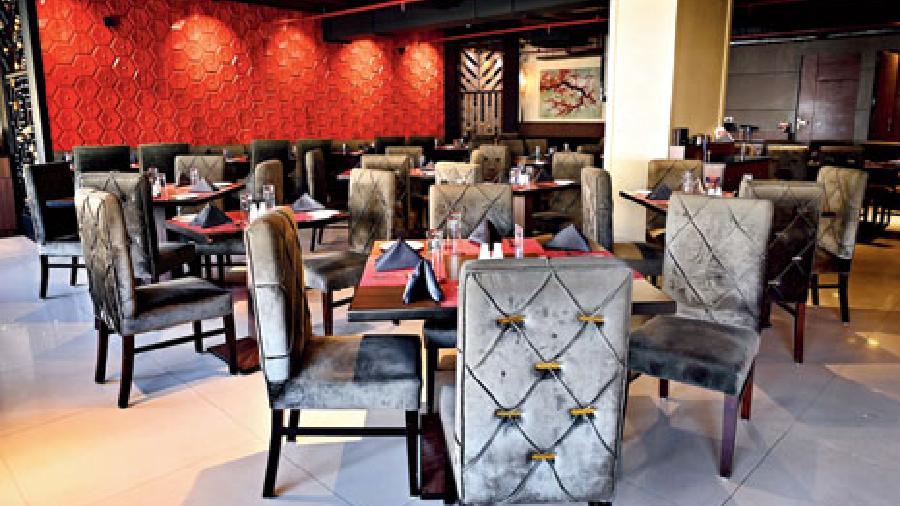 The restaurant has a seating capacity of around 80 people and is spread across an area of around 3,000sqft. It is done in warm tones of reds that are in contrast with the grey upholstery