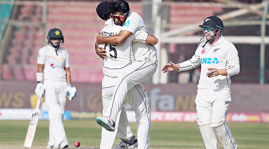 New Zealand’s Ish Sodhi (centre) celebrates with teammates after dismissing Pakistan’s Imam-ul-Haq on the fifth day of the first Test in Karachi on Friday.