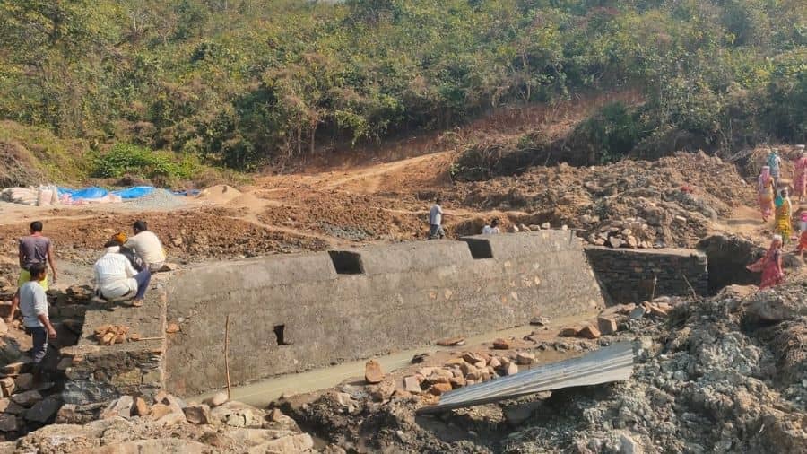 Workers at the under construction check dam inside Dalma wildlife sanctuary. 
