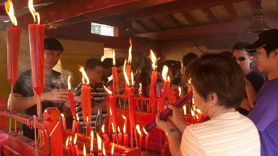 Devotees light candles and incense sticks at the Achipur temple 