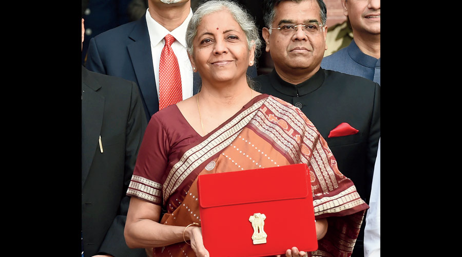 Union Finance Minister Nirmala Sitharaman holds a folder-case containing the Union Budget 2022-23 as she poses for a group photograph with MoS Finance Pankaj Chaudhary and officials of the Finance Ministry, at North Block in New Delhi, Tuesday, Feb. 1, 2022. Sitharaman will be presenting her fourth Union Budget in Parliament. 