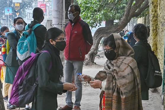 Last-minute sanitisation before entering school — scene in front of Pratt Memorial School on February 3 morning. Schools in West Bengal reopened for offline classes after a month.