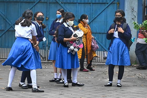 Happy to be together again! Girls wait to enter Sakhawat Memorial Govt. Girls' High School on the first day of reopening on February 3.