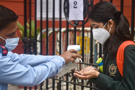 A student of Delhi Public School, Ruby Park, gets her hands sanitised before entering school. Schools have made wearing of mask and frequent sanitisation of hands mandatory in keeping with the New Normal.