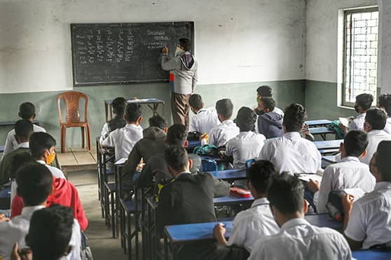 Students take notes in class at Islamia High School.