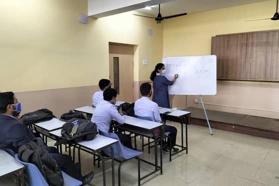 Students and teachers maintain distance in class at Narula Institute of Technology. 