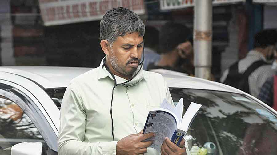 A book in hand, a man was walking down College Street. A mask was hanging from one ear. “Just pulled down my mask. Will wear it again,” he said.