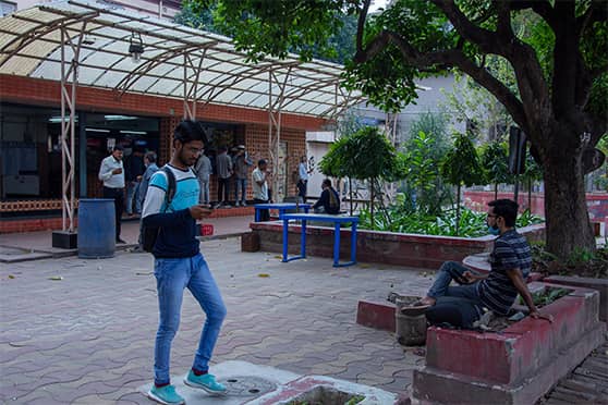 Students take a stroll in front of the administrative office, Aurobindo Bhavan.