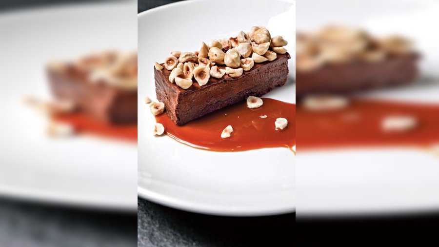 Hazelnut Mousse, French Biscuit and Salted Caramel at The Salt House: A crowd-pleaser, the creamy Nutella with crunchy hazelnuts and a crisp base creates the perfect balance. It is served with home-made salted caramel on the side at the Shakespeare Sarani restaurant. @Rs 575-plus