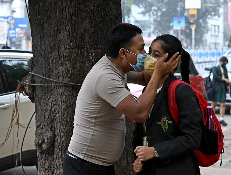 STAY SAFE: A guardian kisses her ward goodbye before she enters the campus on the reopening day at Pratt Memorial School on Wednesday, February 3