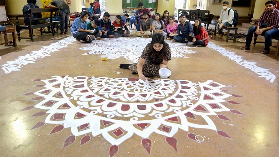 CHALK ART: A student draws a traditional ‘alpona’ at Sanskrit College on Friday, February 4, a day before Saraswati Puja. Colleges and universities reopened in Bengal on February 3