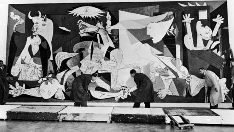Guernica, perhaps the most famous painting by Pablo Picasso, being hung in the Municipal Museum in Amsterdam for an exhibition, 12th July 1956.