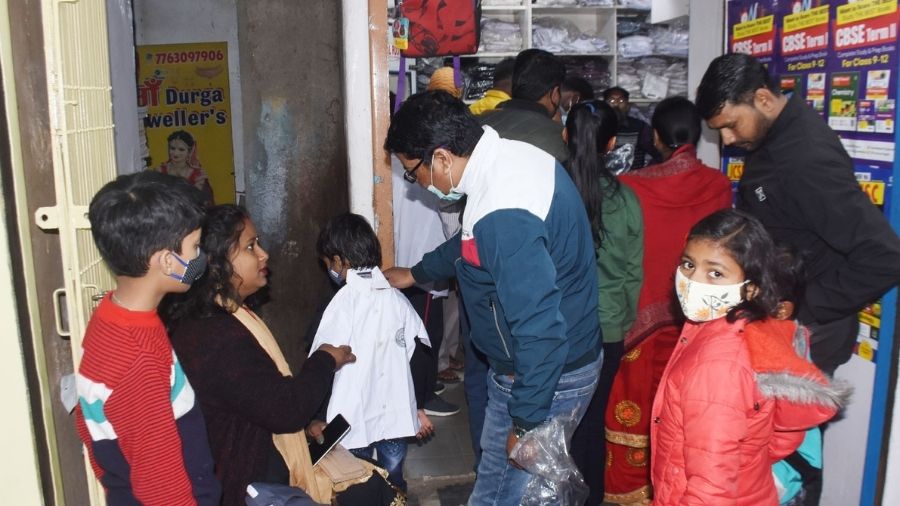 Parents purchasing school uniforms for their kids at Park Market in Hirapur, Dhanbad