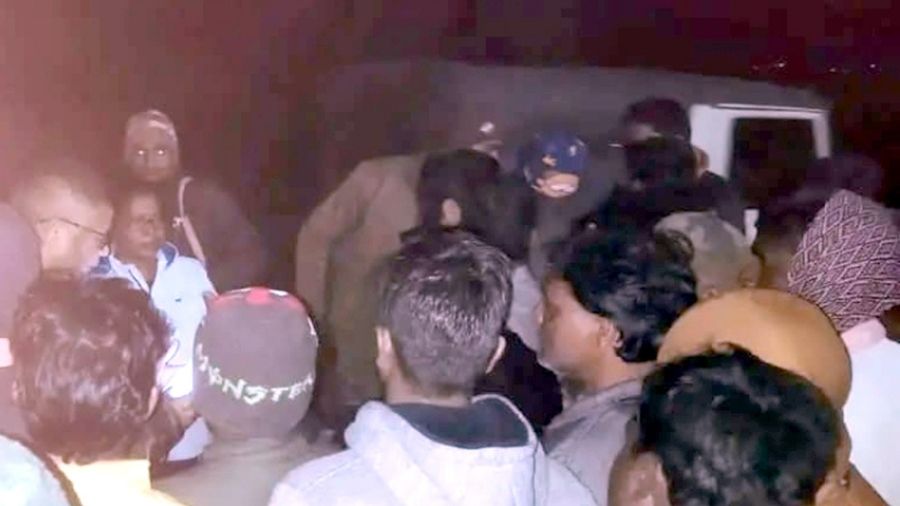 Agitated people gather outside the sub-divisional hospital in Barhi