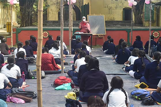 A teacher wears a face mask as she takes classes for primary school girls at a facility in Kolkata used for the Paray Shikshalay campaign.