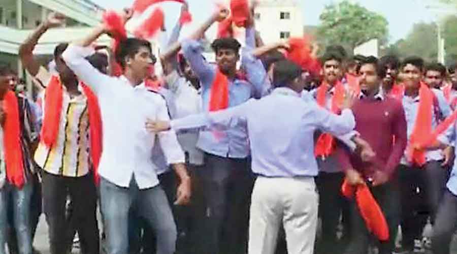 The group of saffron scarf-wearing men at the college.