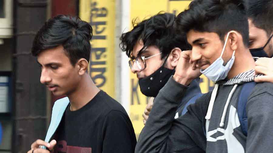 Two of the three boys walking together along Chittaranjan Avenue were wearing masks improperly and the third had his in his hand. “Since we were talking, we loosened the masks a little,” said the boy on the extreme left. 